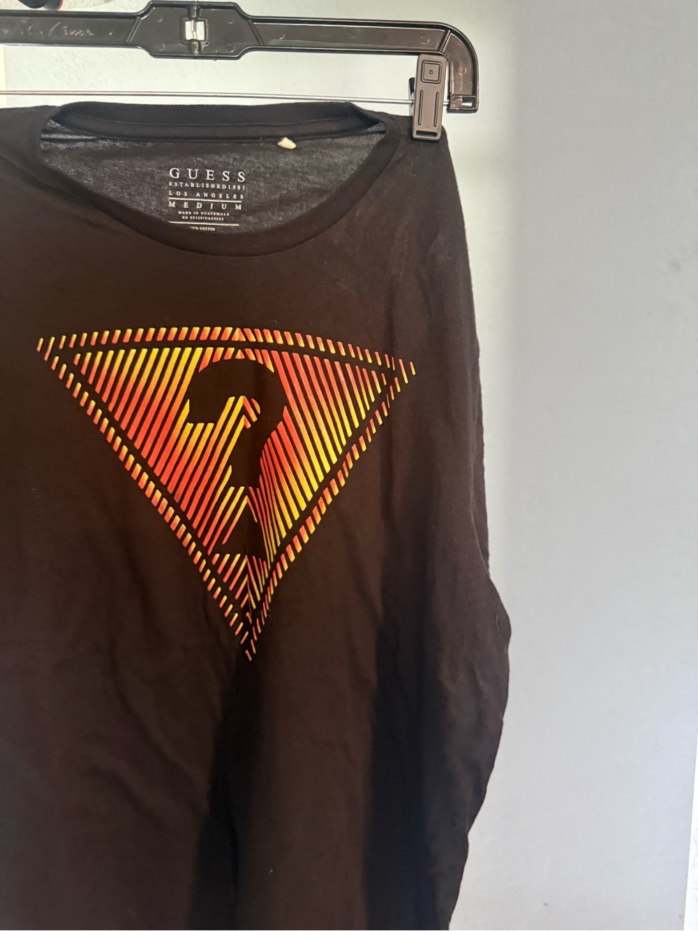 GUESS Black Tee with Yellow and Orange Striped Triangle Logo